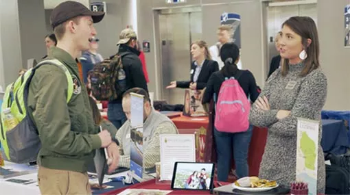 students speaking with a counselor at a transfer admission event