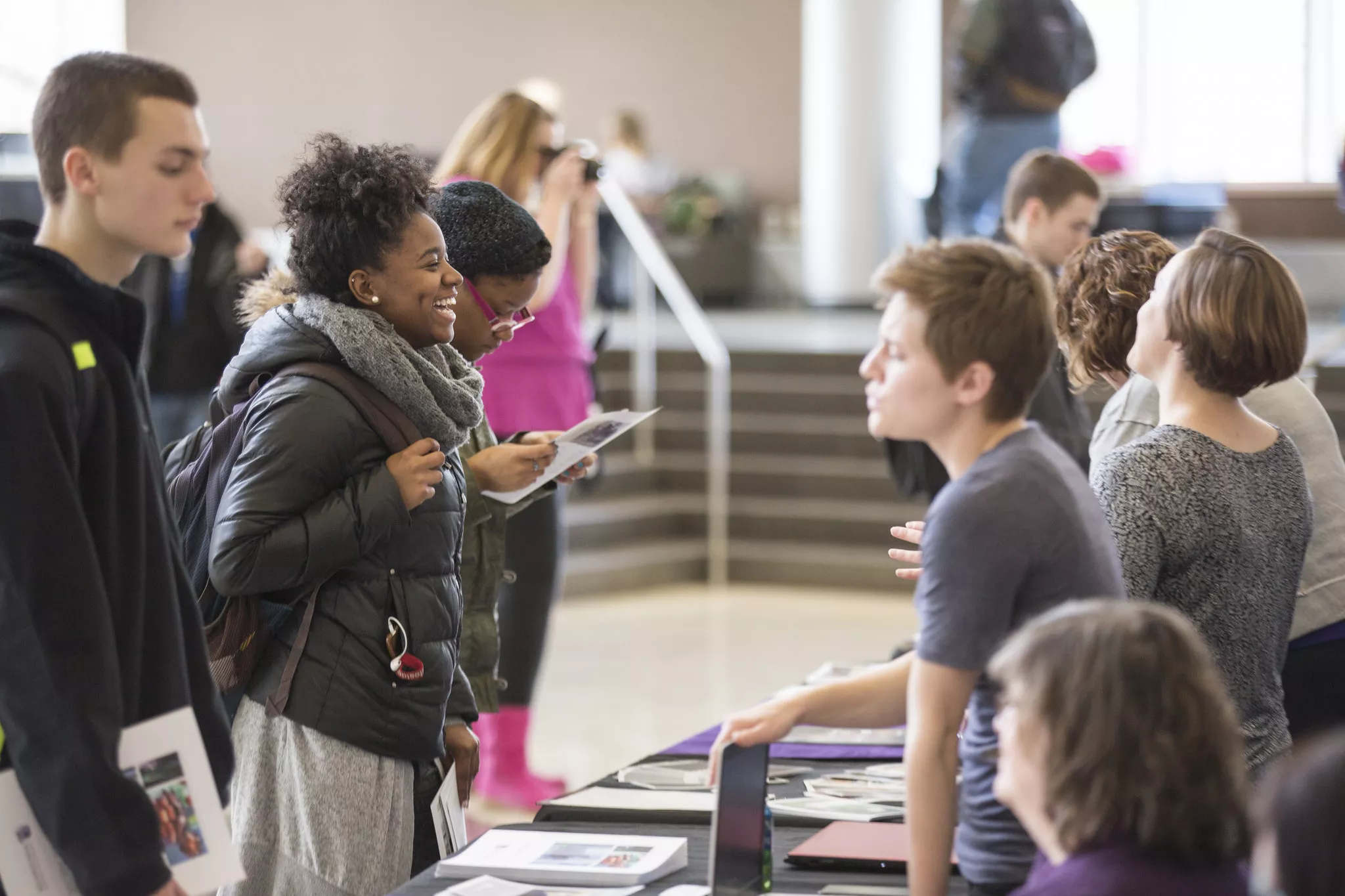 Students talking to advisors behind a booth