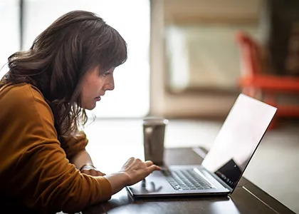 student studying at laptop