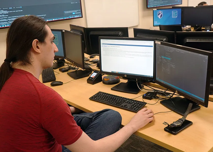 web software developer student coding in class