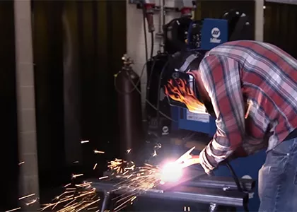 Madison College student using a welder to fabricate metal